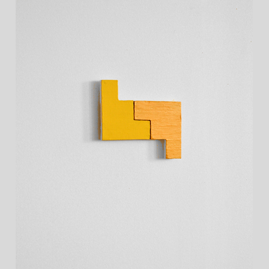 This 2012 wall work by artist Sjak Marks has two diffrent yellow elements.  One of the painted surfaces is flat and the other is glossy